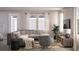 Inviting living room featuring a comfortable gray sectional, neutral tones, and a large window at 167 Aulin Ave, Oviedo, FL 32765