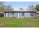 Exterior of home features solar panels, grassy yard and multiple doors at 1834 Willie Mays Pkwy, Orlando, FL 32811