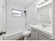 Bathroom with white tile, a tub and shower combo, and a modern vanity with sleek hardware at 1834 Willie Mays Pkwy, Orlando, FL 32811