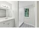 Updated bathroom with decorative tile, vanity and glass enclosed shower at 1834 Willie Mays Pkwy, Orlando, FL 32811