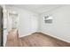 Bedroom featuring wood-look floors, closet and large windows at 1834 Willie Mays Pkwy, Orlando, FL 32811
