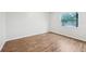 Bright bedroom featuring neutral walls, wood-look flooring and a large window at 1834 Willie Mays Pkwy, Orlando, FL 32811