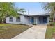 Charming single-story house featuring a gray exterior, solar panels, and a well-maintained front yard at 1834 Willie Mays Pkwy, Orlando, FL 32811
