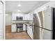 Efficient kitchen equipped with stainless appliances, modern cabinets, and sleek countertops providing functionality at 1834 Willie Mays Pkwy, Orlando, FL 32811