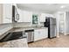 Updated kitchen boasts white cabinets, stainless steel appliances, and granite countertops for a modern feel at 1834 Willie Mays Pkwy, Orlando, FL 32811