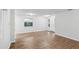 Bright living room with wood-look floors, a window, and a doorway, creating a cozy and welcoming space at 1834 Willie Mays Pkwy, Orlando, FL 32811
