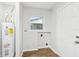 Utility room with water heater, window and updated flooring at 1834 Willie Mays Pkwy, Orlando, FL 32811