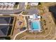 Aerial shot of the community pool, playground, and surrounding neighborhood featuring modern amenities at 187 Aces High Ln, Davenport, FL 33896