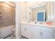 Bathroom featuring double sinks, white cabinets, and shower-tub combination at 187 Aces High Ln, Davenport, FL 33896