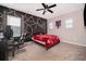 Bedroom featuring a geometric accent wall, a bed and a desk with an ergonomic chair at 187 Aces High Ln, Davenport, FL 33896