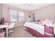 Cozy bedroom featuring a ceiling fan, two windows, and a plush bed at 187 Aces High Ln, Davenport, FL 33896