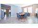 Inviting dining room with neutral walls, gray tile flooring, and stylish decor at 187 Aces High Ln, Davenport, FL 33896