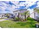 Beautiful home's landscaped front yard and brick driveway lead up to a covered entrance at 187 Aces High Ln, Davenport, FL 33896