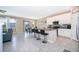 Open kitchen featuring white cabinets, stainless steel appliances, and a gray tile backsplash at 187 Aces High Ln, Davenport, FL 33896