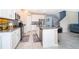 Spacious kitchen featuring white cabinets, stainless steel appliances, and a center island with seating at 187 Aces High Ln, Davenport, FL 33896