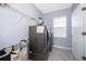 This functional laundry room offers a modern washer and dryer, overhead shelf, and convenient storage at 187 Aces High Ln, Davenport, FL 33896