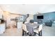 Open concept living room and kitchen space featuring modern furnishings and neutral colors at 187 Aces High Ln, Davenport, FL 33896