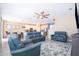 Open-concept living room with ceiling fan, adjacent kitchen and dining area at 187 Aces High Ln, Davenport, FL 33896