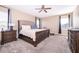 Main bedroom featuring a carpeted floor, a ceiling fan and large windows at 187 Aces High Ln, Davenport, FL 33896