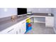 Office features custom built-ins, quartz countertop and under cabinet storage at 187 Aces High Ln, Davenport, FL 33896