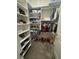 Walk-in closet with built-in shelves and rods for optimal clothing storage at 187 Aces High Ln, Davenport, FL 33896