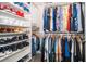 Organized walk-in closet with shelves and hanging racks for clothes and shoes at 187 Aces High Ln, Davenport, FL 33896