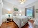 Well-lit bedroom with hardwood floors, a ceiling fan and a sun-filled window seat at 2026 Willow Lauren Ln, Windermere, FL 34786