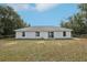 Expansive backyard featuring a privacy fence and ample space for outdoor activities and relaxation at 25 Maple Crse, Ocklawaha, FL 32179