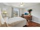 Bright bedroom with wood floors, natural light, dresser and ceiling fan at 25 Maple Crse, Ocklawaha, FL 32179