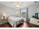This bedroom has a ceiling fan, wood floors and a window with bright, natural light at 25 Maple Crse, Ocklawaha, FL 32179