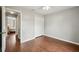 Neutral bedroom with hardwood floors, a closet, and a doorway leading to other rooms at 25 Maple Crse, Ocklawaha, FL 32179