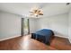 Inviting bedroom with wood flooring, a ceiling fan, and a window with natural light at 25 Maple Crse, Ocklawaha, FL 32179