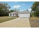 Charming single Gathering home featuring well-maintained landscaping and a two-car garage at 25 Maple Crse, Ocklawaha, FL 32179