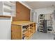 Garage with a workbench, pegboard, and storage shelves for tools and equipment at 25 Maple Crse, Ocklawaha, FL 32179