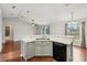 Kitchen sink featuring gray cabinets, hardwood floors, and view to the living room at 25 Maple Crse, Ocklawaha, FL 32179