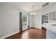 Cozy dining area with hardwood floors, chandelier, and view to the backyard at 25 Maple Crse, Ocklawaha, FL 32179