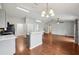 Kitchen and living room combination featuring a breakfast bar and hardwood floors at 25 Maple Crse, Ocklawaha, FL 32179
