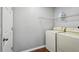 Laundry room with washer, dryer and storage shelves for household goods at 25 Maple Crse, Ocklawaha, FL 32179