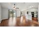 Bright living room with hardwood floors, ceiling fan, vaulted ceiling, and access to the kitchen at 25 Maple Crse, Ocklawaha, FL 32179
