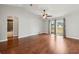 Bright main bedroom with hardwood floors, ceiling fan, vaulted ceiling, and access to the bathroom at 25 Maple Crse, Ocklawaha, FL 32179