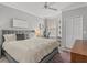 Comfortable bedroom with a gray headboard, fluffy white comforter, and a window with natural light at 2639 Maitland Crossing Way # 3, Orlando, FL 32810