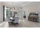 Bright dining room featuring wood-look tile floors, a chandelier, and natural light from large windows at 31746 Red Tail Blvd, Sorrento, FL 32776