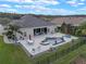 Aerial view of the backyard featuring a patio, outdoor seating, and a uniquely shaped pool and spa at 31746 Red Tail Blvd, Sorrento, FL 32776