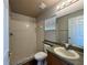 Bright bathroom features a shower with tile surround and a vanity with generous countertop space at 324 Anchovie Ct, Kissimmee, FL 34759