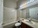 Bright bathroom features a shower-tub combo and vanity sink with mirror at 324 Anchovie Ct, Kissimmee, FL 34759