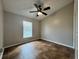 Bedroom with tile floors, ceiling fan and natural light from a window at 324 Anchovie Ct, Kissimmee, FL 34759