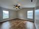 Large bedroom with two windows, ceiling fan, and neutral paint at 324 Anchovie Ct, Kissimmee, FL 34759
