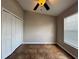 Cozy bedroom features tile floors, a ceiling fan, a window, and a closet at 324 Anchovie Ct, Kissimmee, FL 34759