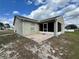 Home's exterior shows a screened in lanai, an outdoor patio, and a well-maintained yard at 324 Anchovie Ct, Kissimmee, FL 34759