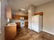 Functional kitchen features wood cabinets, white appliances, and tile flooring at 324 Anchovie Ct, Kissimmee, FL 34759